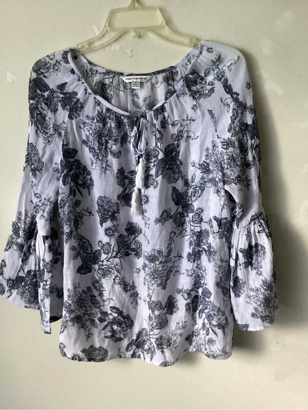 Counterparts bell sleeve pullover blouse.